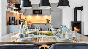 A modern kitchen with a dining area set for a meal. - Cozy apartment in Olpenitz with sauna (Olpenitz)