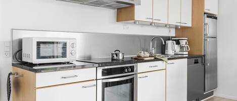 Fridge, stovetop, dishwasher, coffee/tea maker