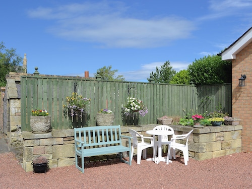 Lovely property with an open staircase leading to 2 bedrooms and a bathroom.