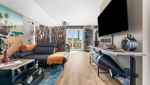 A modern living room with a sofa, a coffee table, and a TV mounted on the wall. - Gorgeous apartment in Olpenitz (Olpenitz)