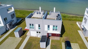 A modern building with a flat roof, multiple windows, and a small attached garage. - Nice home in Olpenitz with sauna (Olpenitz)