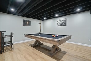 A pool table with a wooden frame and a pool cue, a pool table with a wooden frame and a pool cue, a pool table with a wooden frame and a pool cue, a pool table with a wooden frame and a pool cue, a pool table with a wooden frame and a pool cue.