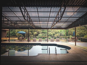 Indoor pool, pool umbrellas, pool loungers