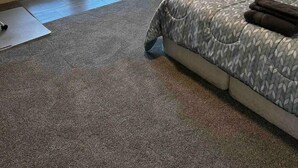 A bedroom with a bed, a sliding glass door to a balcony, and a carpeted floor. - Quiet corner on Burman (Gold River)