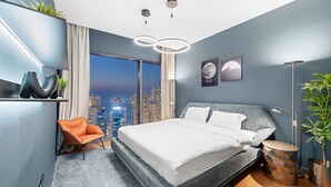 A modern bedroom with a large bed, a city view, a plant, and a unique wall shelf. - Dubai Marina 3BR in Vida | Pool, Gym, Balcony, Walk Everywhere (Dubai)