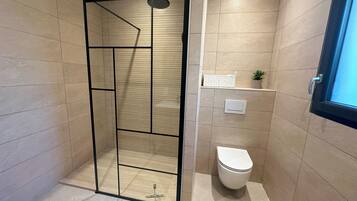 Shower, towels, soap, toilet paper