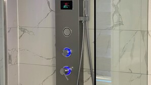 A modern shower with a digital display, multiple water temperature settings, and a handheld showerhead. - First Class - 2 bedroom house  (Whitby)