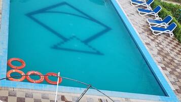 Outdoor pool, open 8:00 AM to 6:00 PM, pool umbrellas