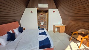 A bedroom with a bed, a desk, and a chair. - PATANG FAMILY RESORT (Talala)