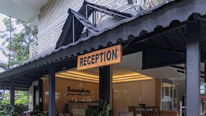 A reception area with a sign, potted plants, and a travel desk. - Basundhara Resort Pokhara (Pokhara)