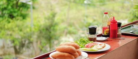 A dining table with a plate of food, condiments, and a bottle of water.