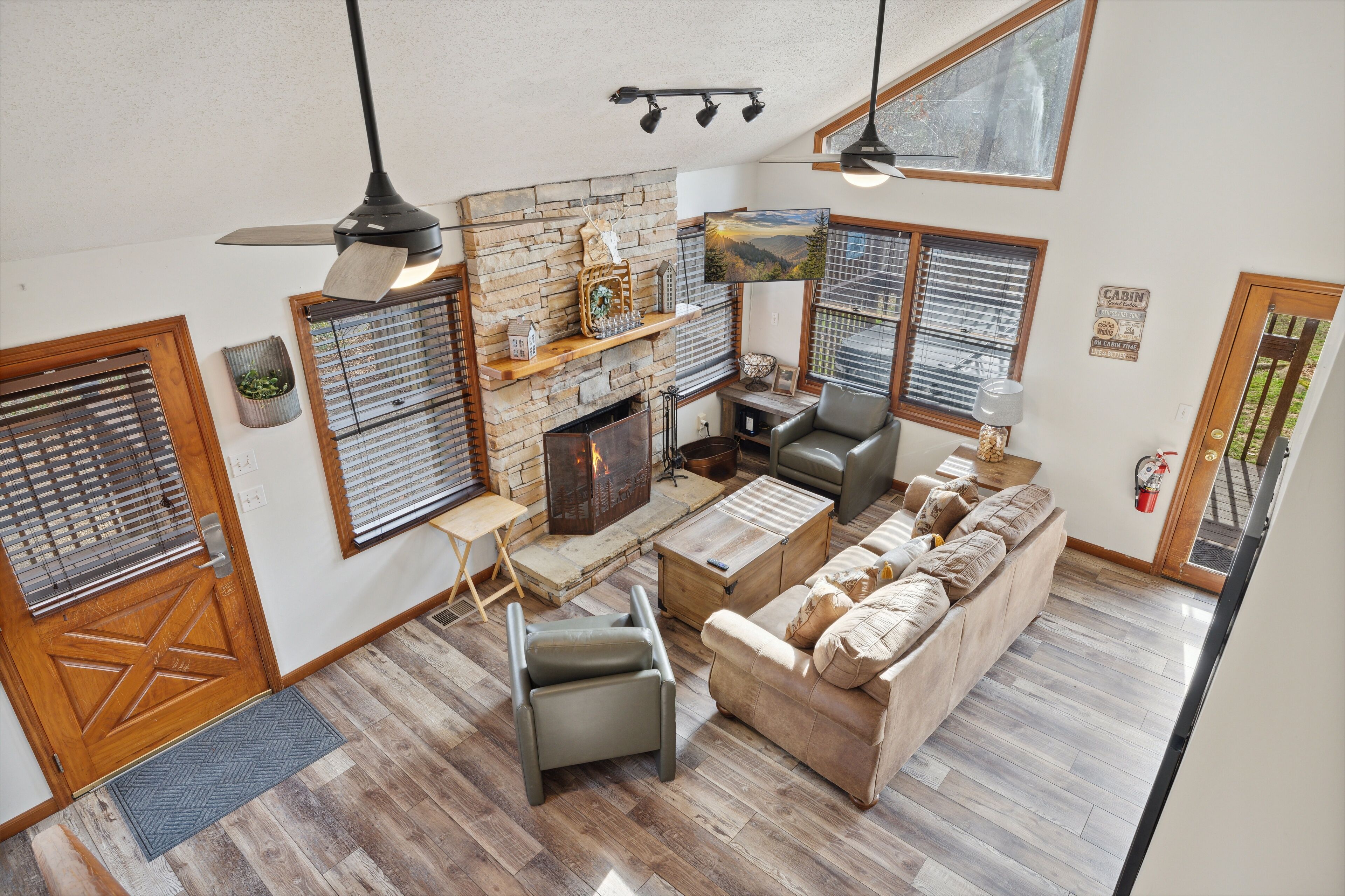 A spacious living area with a fireplace, a sofa, a coffee table, and a dining table.