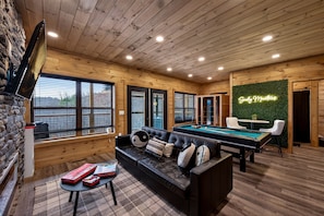 A cozy room with a pool table, a black leather sofa, and a neon sign reading "Family Matters." - Jerne Of A Lifetime 4 Bedroom Cabin by RedAwning (Sevierville)