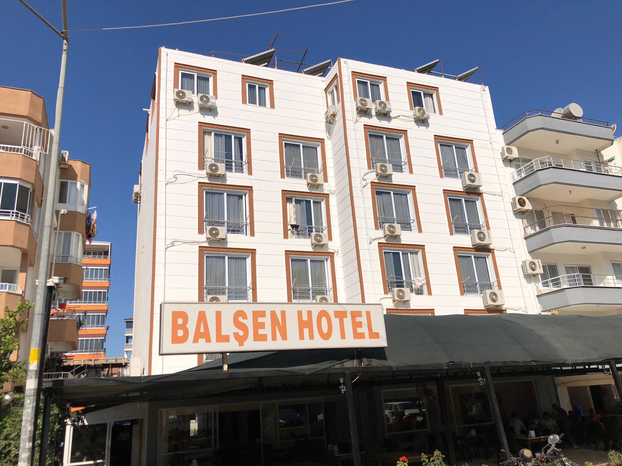 A multi-story hotel with a sign reading "BALSEN HOTEL".