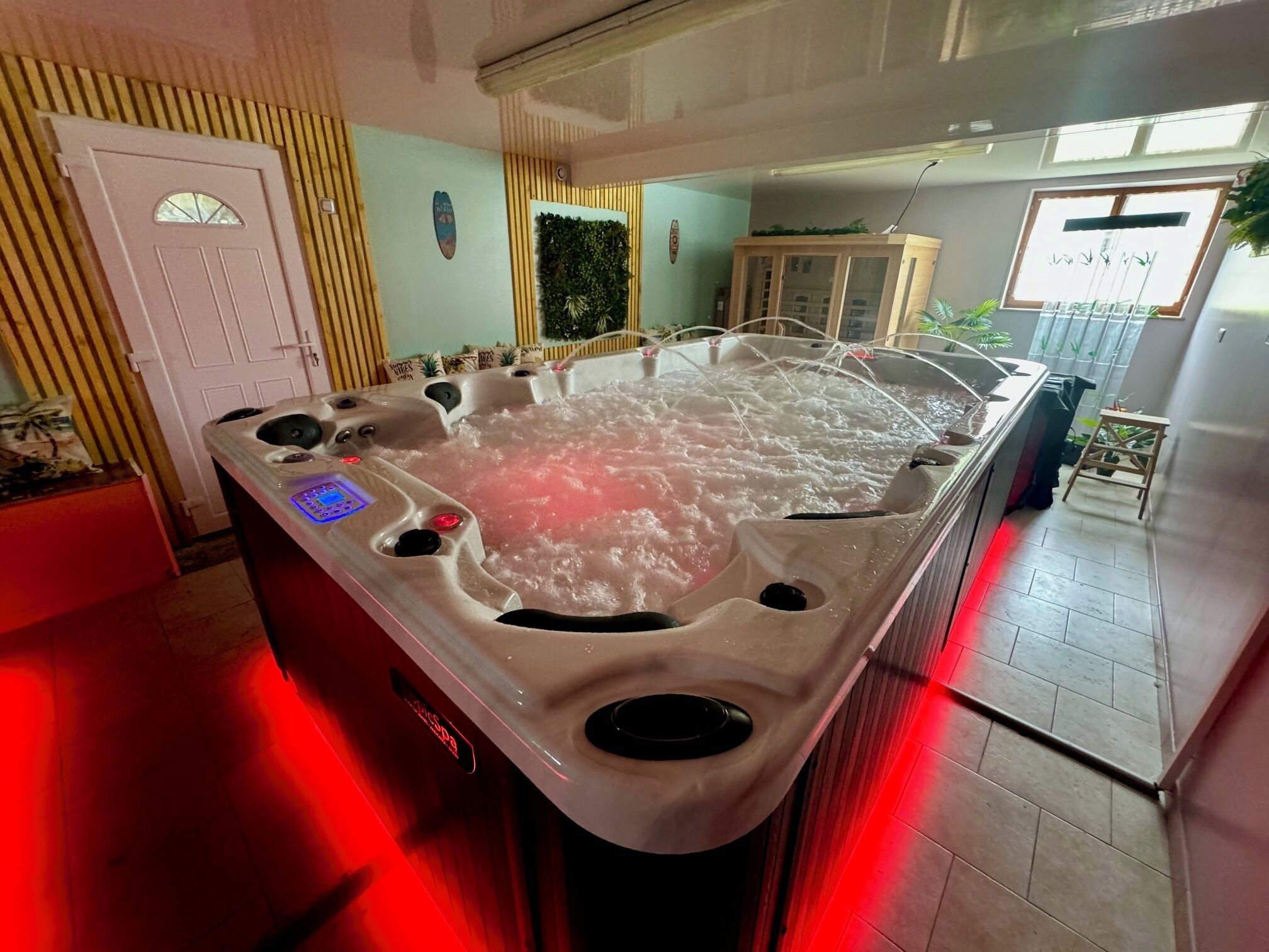 A hot tub with multiple jets, a control panel, and a digital display.