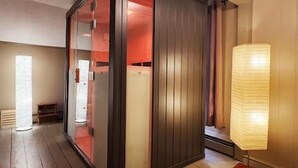 A modern room with a sliding door leading to a bathroom, a tall floor lamp, and a wooden floor. - Romantic Wine Country Retreat Spa-Hot Tub & Sauna (Burdett)