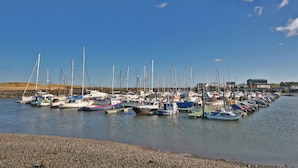 A marina with numerous boats docked along the shore. - 4 bedroom accommodation in Red Row near Amble (Red Row near Amble)