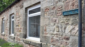 A stone building with a sign reading "The Old Reading Room".