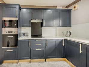 A kitchen with dark cabinets, a microwave, a toaster, and a kettle. - A peaceful location for a relaxing break with excellent fishing to enjoy. (Marston)