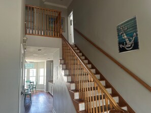 A staircase with wooden balusters leading to a second floor.