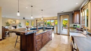 A spacious kitchen with a large island, dark wooden cabinets, and pendant lighting. - Templeton Retreat • Pool, Spa • Near Wineries (Templeton)