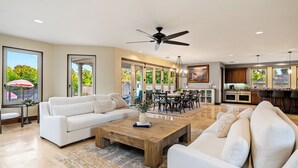 A spacious living room with a white sofa, a wooden coffee table, and a ceiling fan. - Templeton Retreat • Pool, Spa • Near Wineries (Templeton)