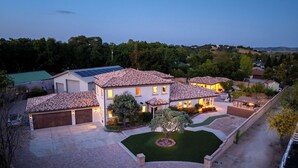 A residential area with multiple houses, a driveway, and a well-maintained lawn. - Templeton Retreat • Pool, Spa • Near Wineries (Templeton)