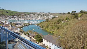 A coastal town with a marina, residential buildings, and a hill with sparse vegetation. - 3 bedroom accommodation in Kingswear (Kingswear)