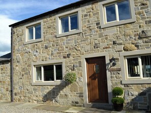 A stone building with multiple windows, a wooden door, and a sign reading 'Fallow House.' - 4 bedroom accommodation in Paythorne, near Skipton (Paythorne, near Skipton)
