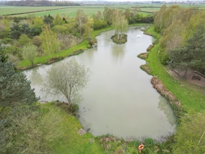 A river meandering through a park with trees and grassy banks.