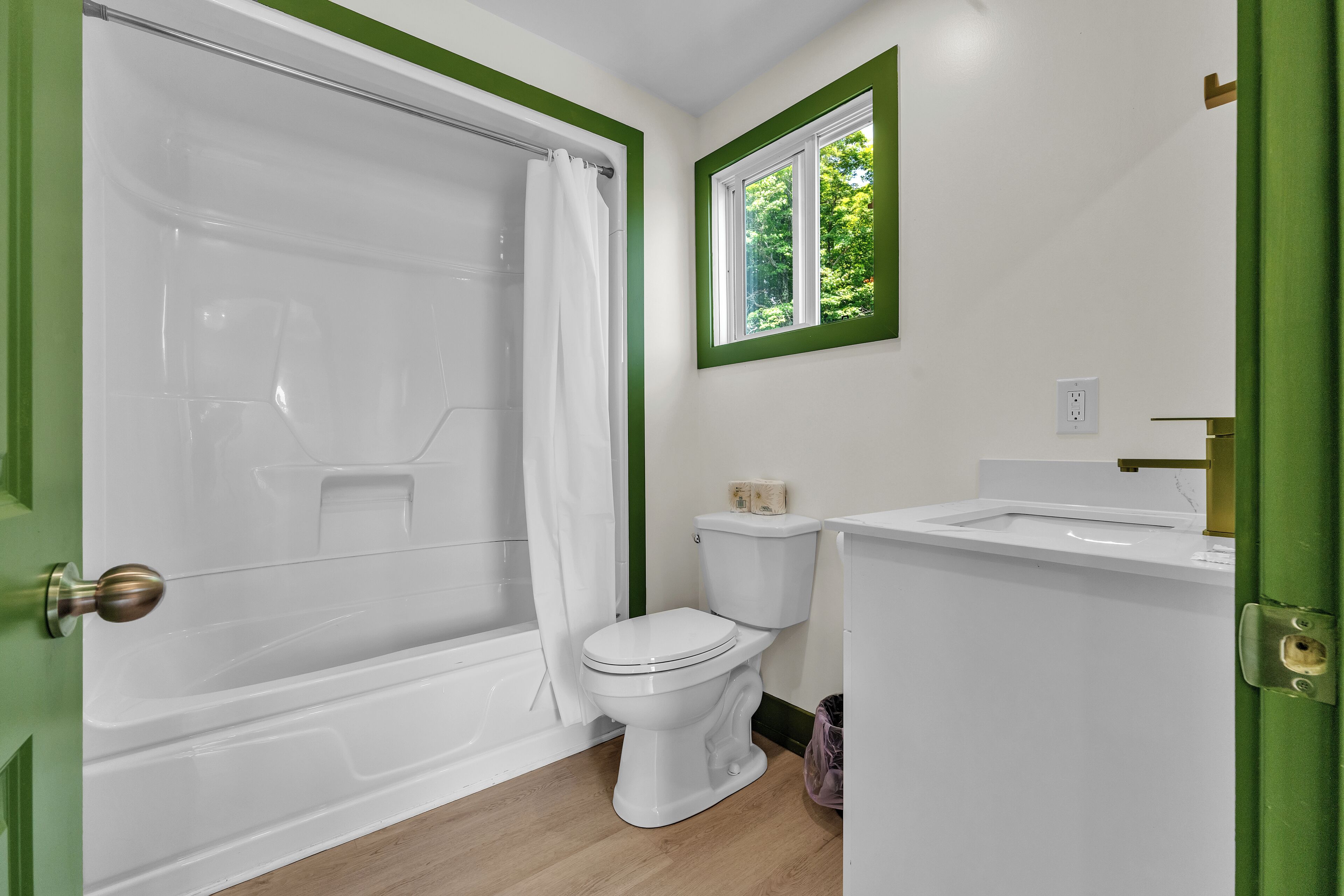 A bathroom with a bathtub, toilet, and sink.