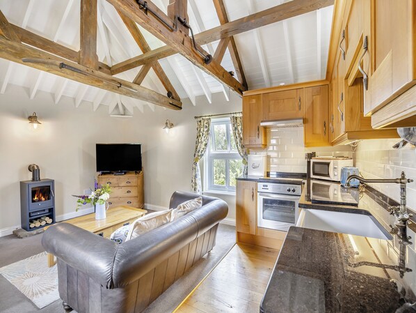 A cozy living room with a fireplace, a sofa, and a television.