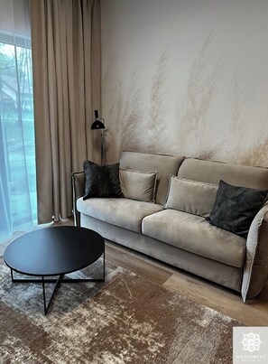 Relax in this stylish living room with a sofa, floor lamp, and coffee table.