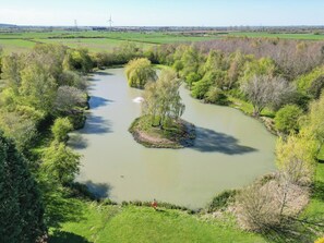 A river meandering through a lush landscape with trees and a small island in the center.