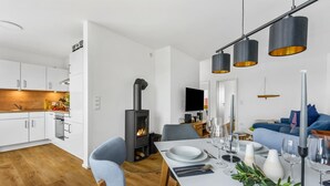 A modern kitchen with white cabinets, a built-in oven, and a stove. - 2 bedroom beach front home in Olpenitz (Olpenitz)
