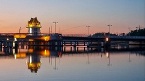 A bridge with a lighthouse at the end, over a calm body of water. - Pet friendly apartment in Olpenitz (Olpenitz)