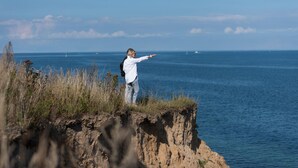 A person standing on a cliff overlooking the ocean. - Pet friendly apartment in Olpenitz (Olpenitz)