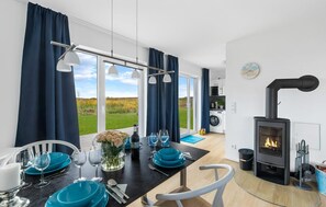 Enjoy a meal for two in the dining area with a view of the surrounding grassy field.