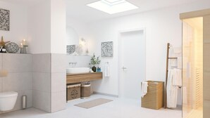 A modern bathroom with a skylight, a freestanding bathtub, a wooden vanity, and a glass shower enclosure. - Beach front apartment in Olpenitz (Olpenitz)