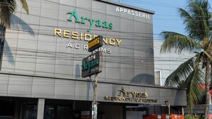 A building with signage for Aryaas Residency/A/Rooms, indicating it is a hotel or residential building. - Aryaas Residency Nettoor (Kanayannur)