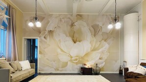 A spacious living room with a large floral mural on the wall, a neutral color scheme, and modern furnishings.