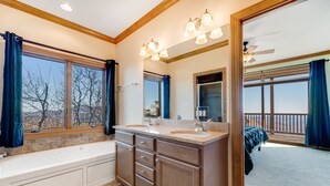 A bathroom with a bathtub, double sinks, and a large mirror. - Comfy Condo At Top Of Sugar Mtn - Ski In Ski Out - AC, WiFi (Sugar Mountain)