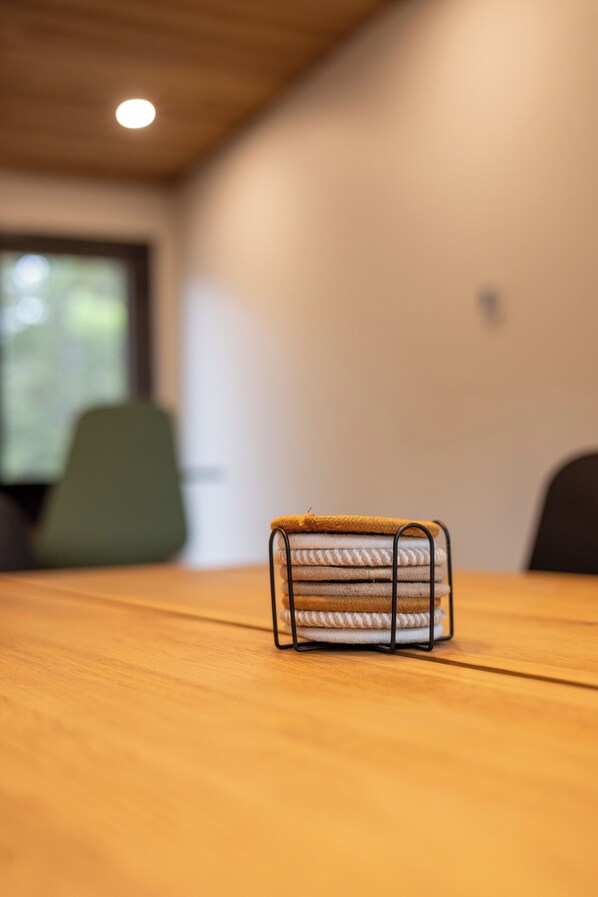 A wooden table with a metal towel rack holding folded towels.
