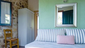 A room with a bed, a chair, a wardrobe, and a mirror on the wall. - Studio Apartment 'Adamantia Newly Built Apartment A2' with Shared Terrace (Gaios)