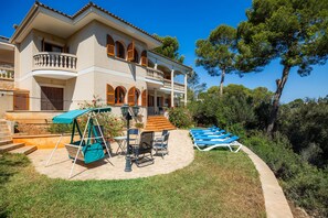 A two-story house with a balcony, outdoor seating, and a pool area. - Villa 'Ca Ses Mestres' with Sea View, Private Terrace and Wi-Fi (Santanyí)