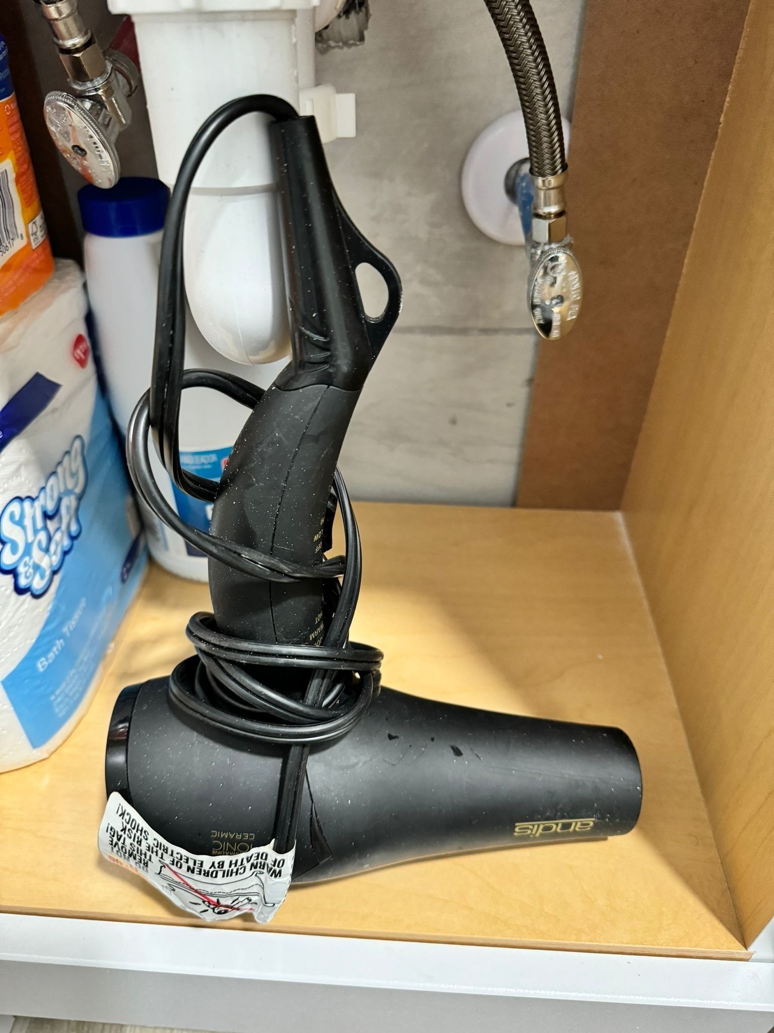 A black electric toothbrush in a wooden box.
