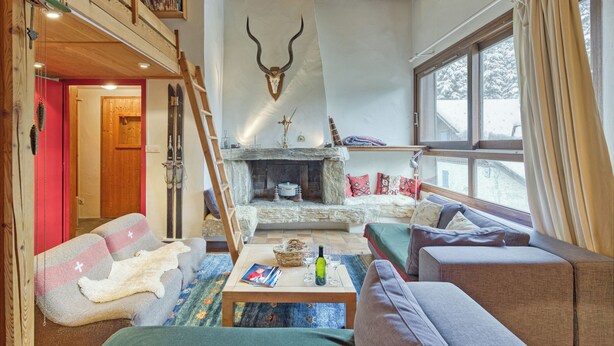 A cozy living room with a fireplace, a high wooden ceiling, and a ski rack. - Apt Le Grenier Ski-in/Ski-out views, sleeps 7, Le Tour (Argentière), France (Le Tour (Argentière))