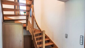 A wooden staircase with a built-in cabinet at the bottom.