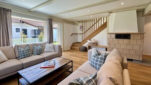 A spacious living room with a sofa set, a coffee table, and a fireplace. - Melvill by Interhome (Dittishausen)