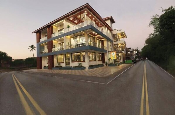 Two-story hotel with modern design, featuring large windows and balconies.